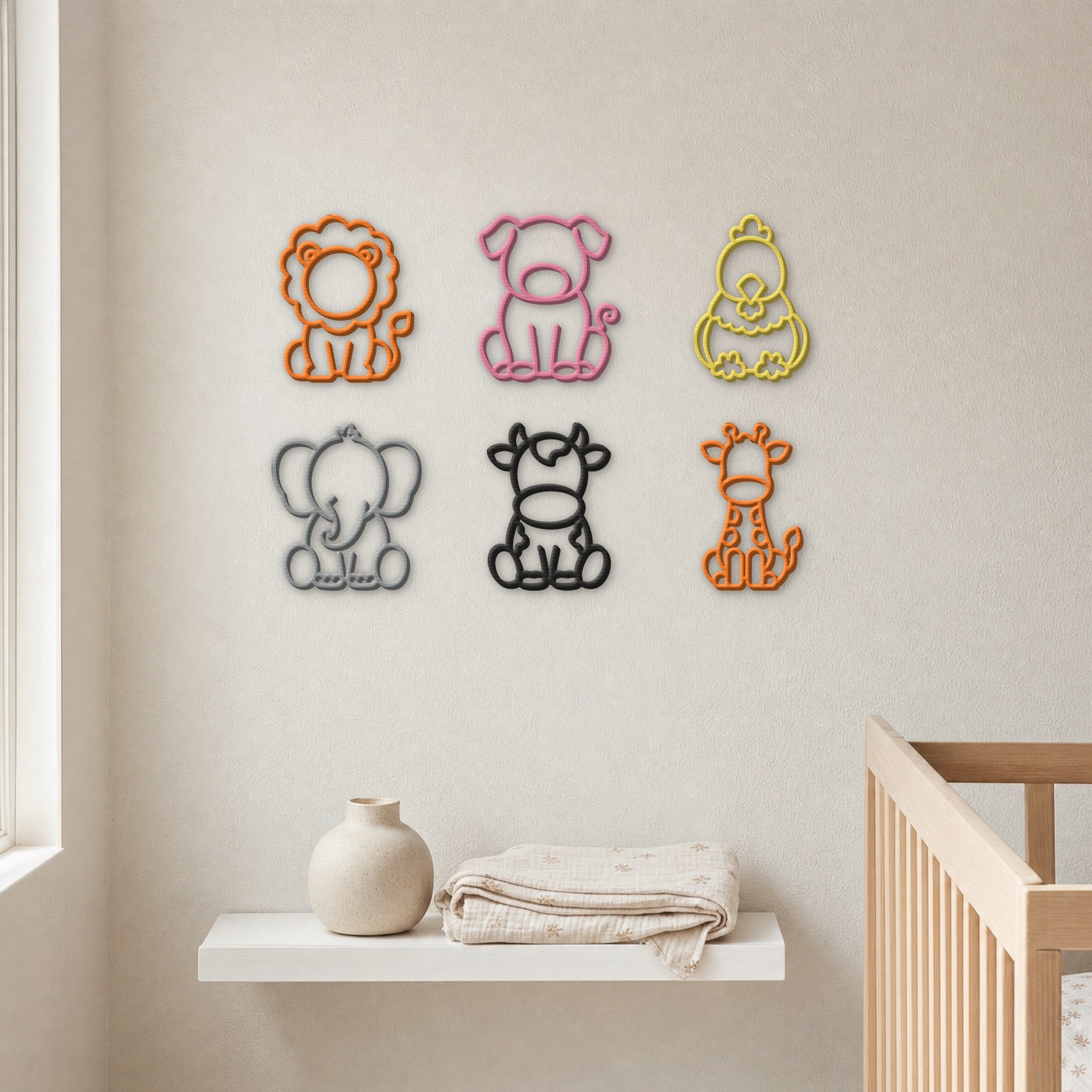 A mix of 3D printed animal wall art designs grouped on a nursery wall