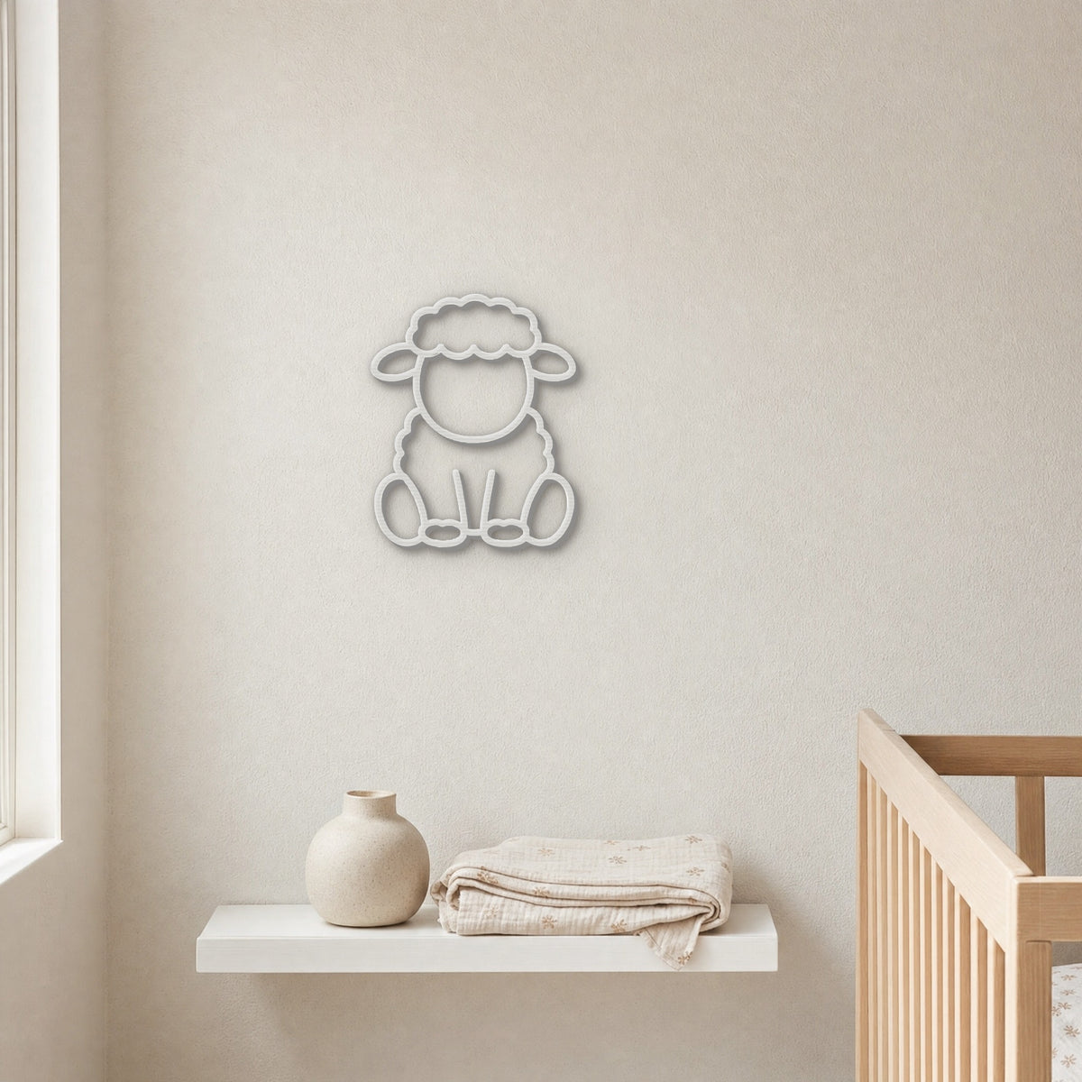 White 3D printed sheep wall art above a nursery shelf