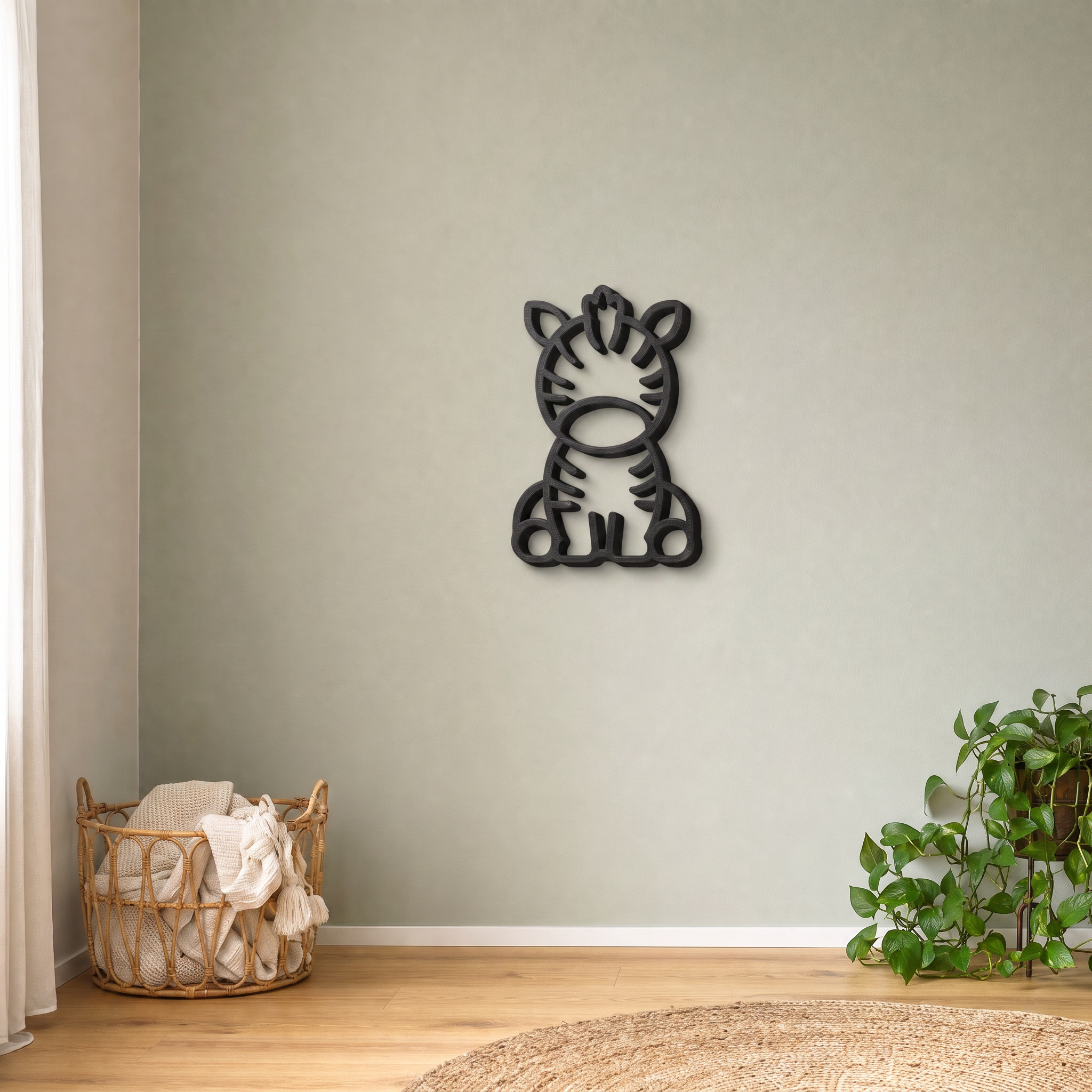 Black zebra wall art on a sage green nursery wall