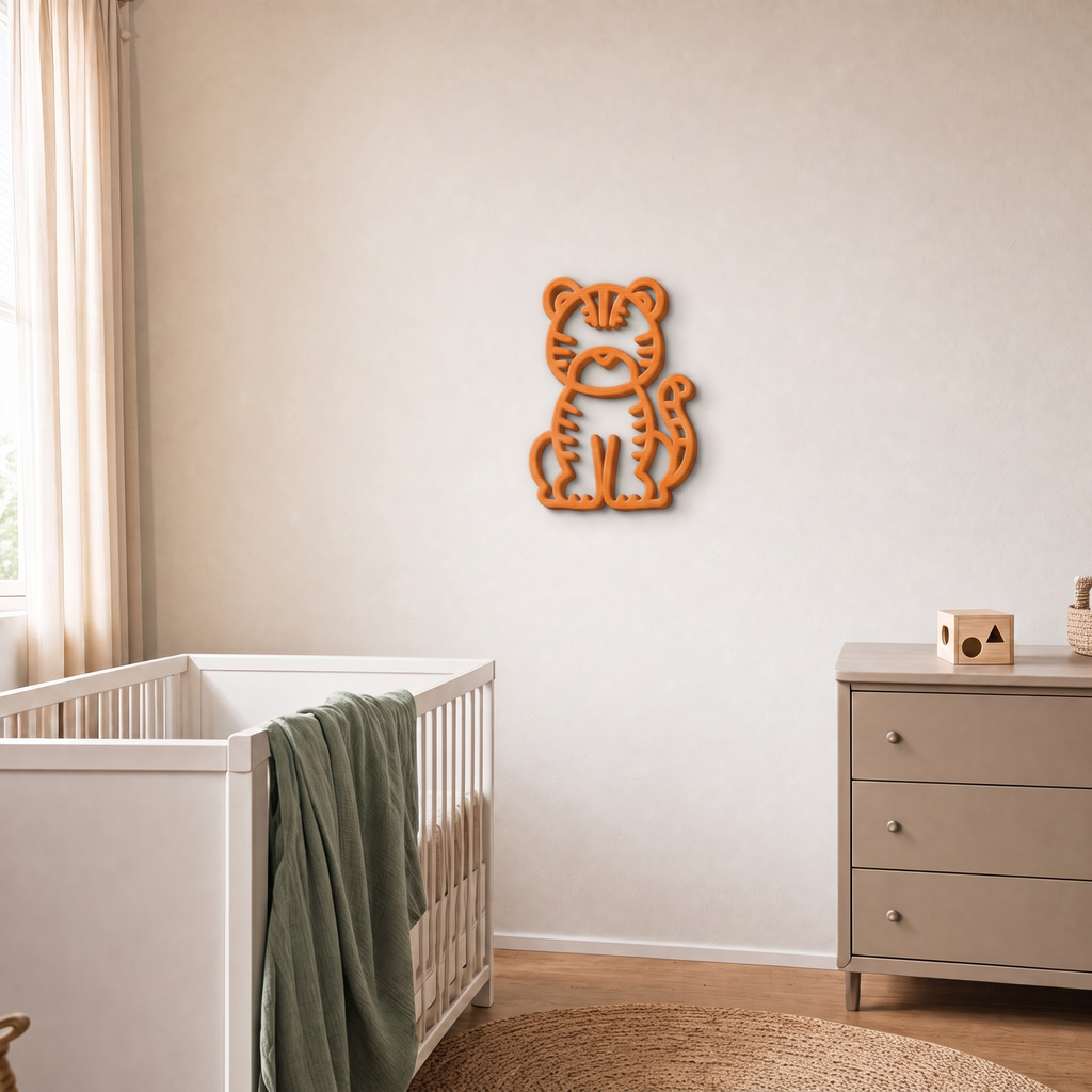 Orange 3D printed tiger wall art in a nursery with cot and drawers